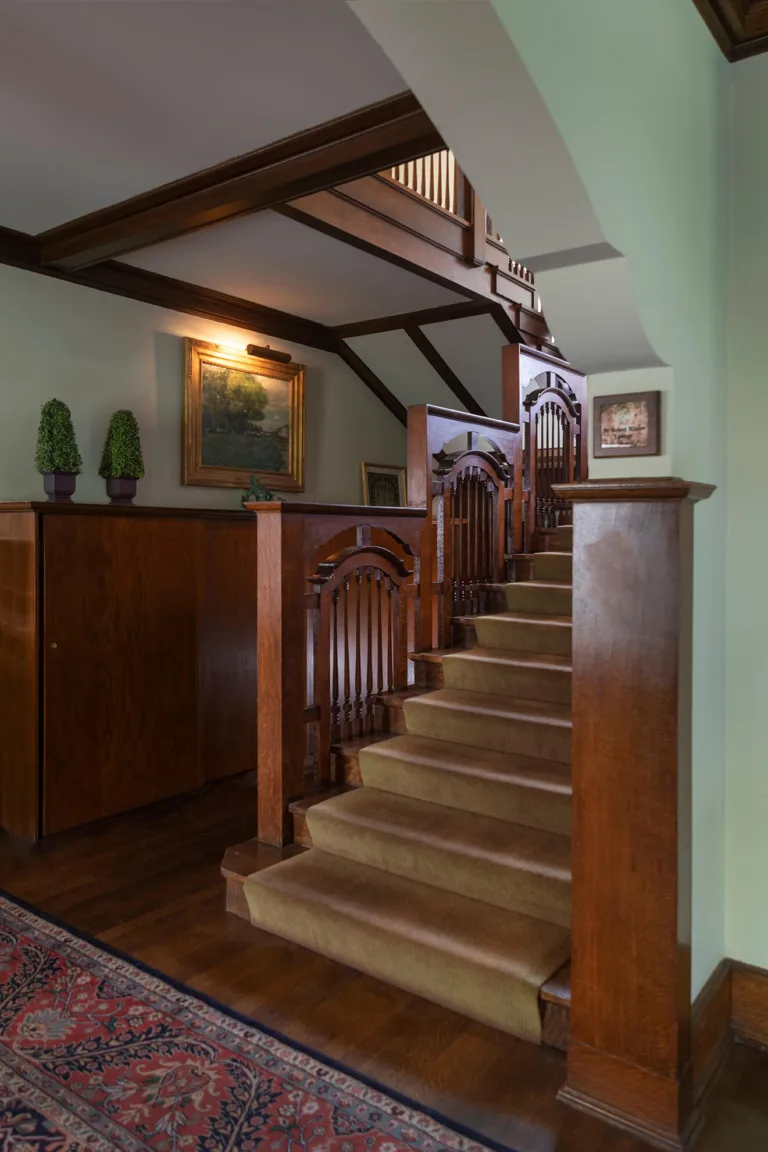 First floor staircase of the Blinn House showing detailed work work containing the broken-arch pattern.